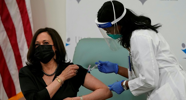 Harris vaccinated on camera, urges public to trust process