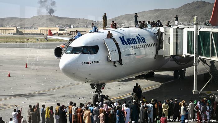 7 Afghans killed in chaos at Kabul airport; fighters seize areas from Taliban